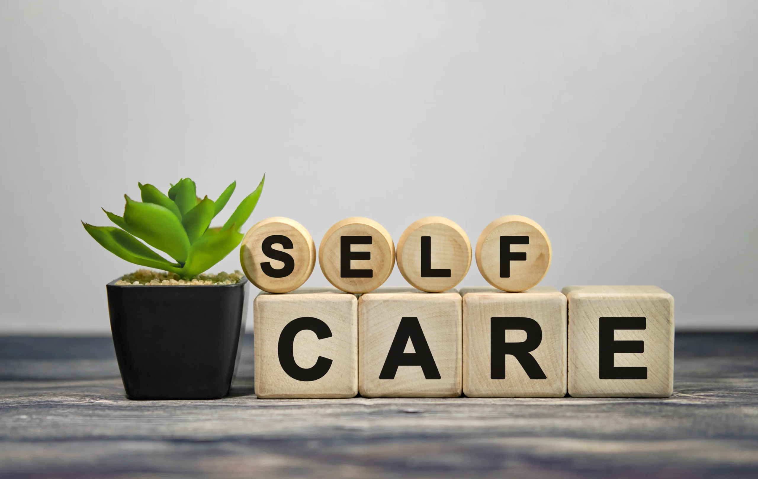 Self care displayed as a word in wooden boxes| nova vitacare | Texas